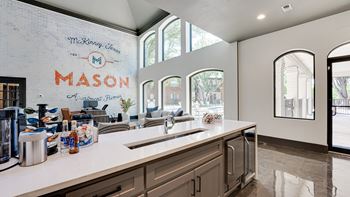 A kitchen with a large island and a sink.